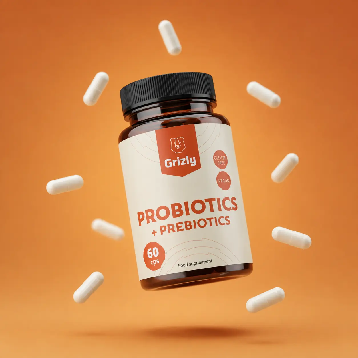 Balení Probiotik a prebiotik Grizly s bílými kapslemi na oranžovém pozadí